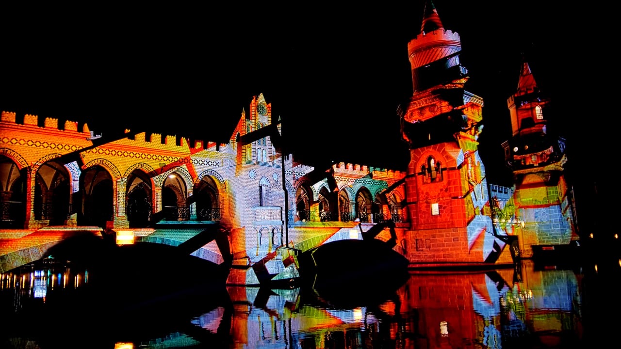 The towers and arches of Berlin's Oberbaumbrücke at night under an unannounced 3D projection mapping by RE:SORB